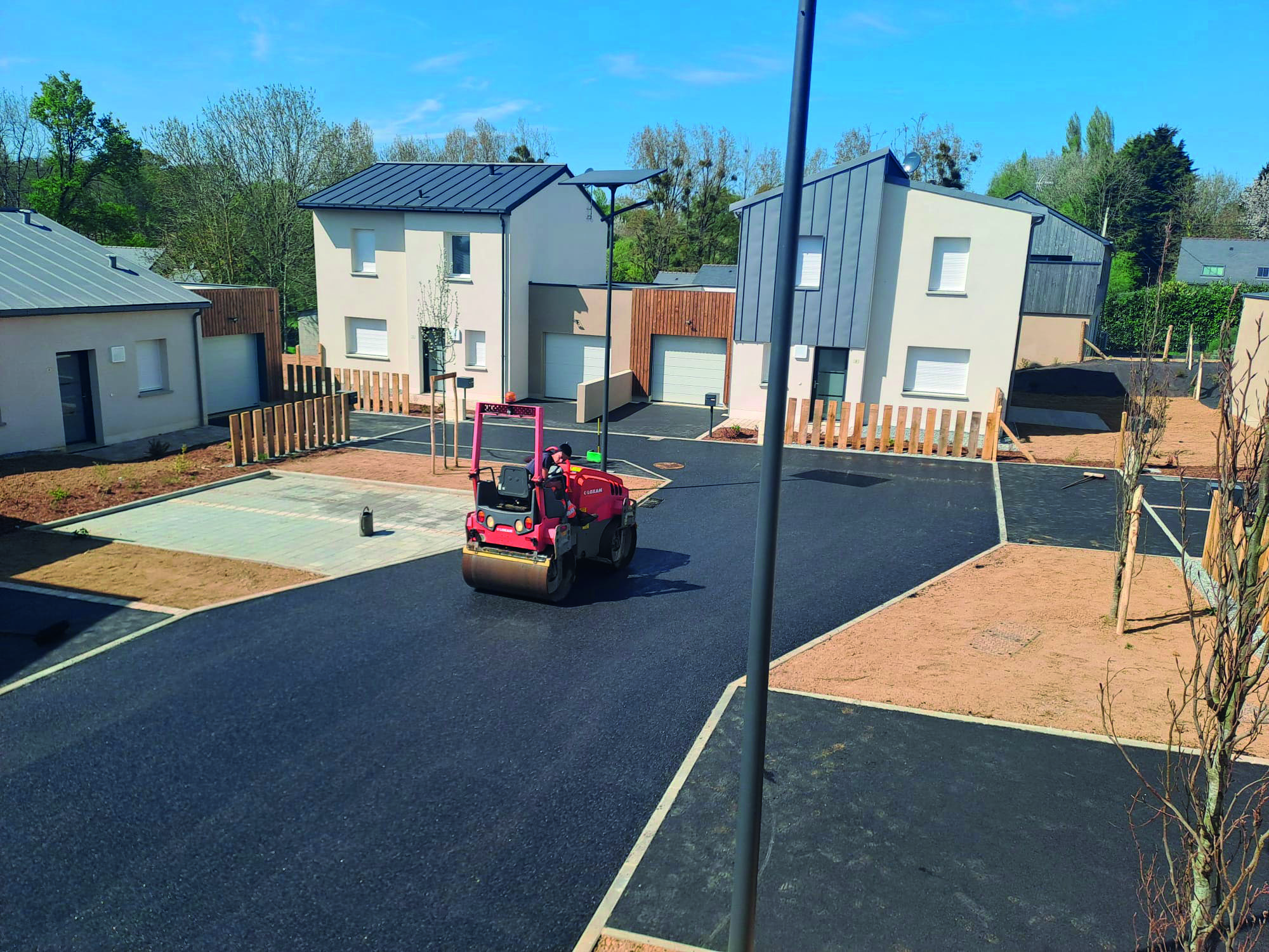 Compactage d'un enrobé neuf au cylindre dans un lotissement