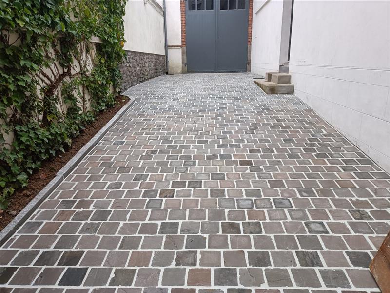 Cour d'entrée en pavés de grès gris posés en quinconce, à Laval